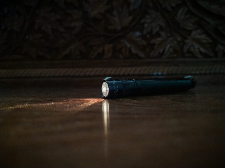 Flashlight on the floor of a dark room during a power outage